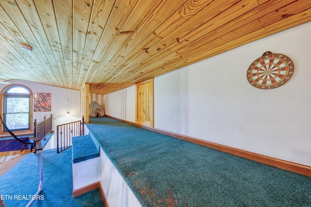 additional living space with wood ceiling and carpet floors