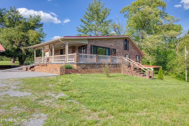 view of front of home featuring brick siding, a front lawn, and a porch