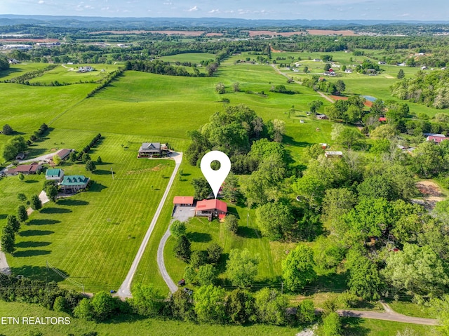 birds eye view of property with a rural view