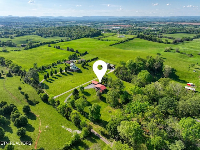 birds eye view of property featuring a mountain view and a rural view
