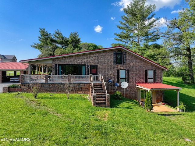 rear view of house with a wooden deck, brick siding, a patio area, a lawn, and stairway