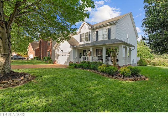 traditional home with covered porch, driveway, and a front yard
