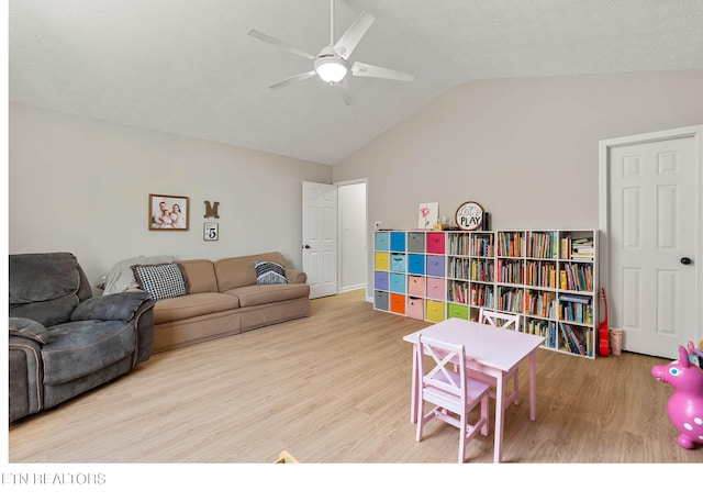 interior space featuring a ceiling fan, wood finished floors, and lofted ceiling