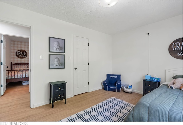 bedroom with light wood-style floors and baseboards