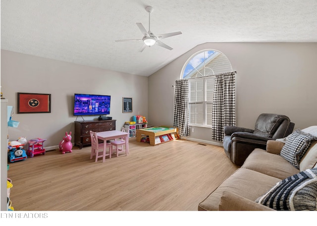 rec room with a ceiling fan, baseboards, vaulted ceiling, and light wood-type flooring