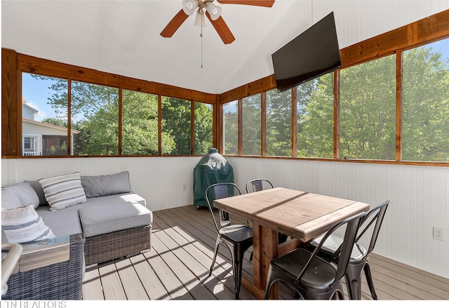 sunroom featuring a healthy amount of sunlight, ceiling fan, and an outdoor living space
