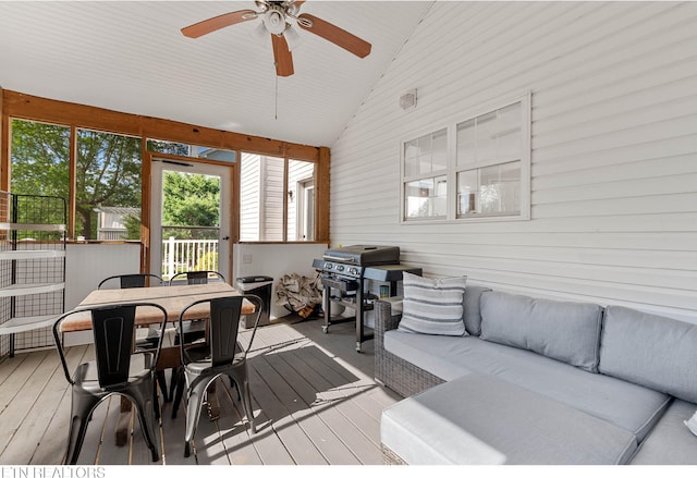 sunroom / solarium featuring a ceiling fan, an outdoor hangout area, and outdoor dining space