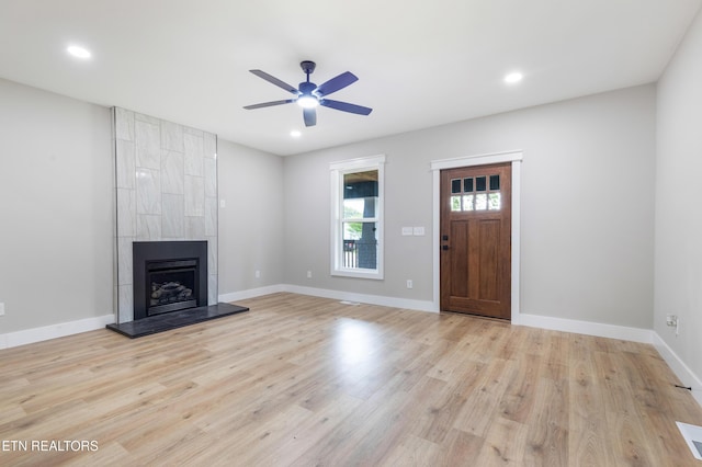 unfurnished living room with light wood-style floors, recessed lighting, ceiling fan, and a large fireplace