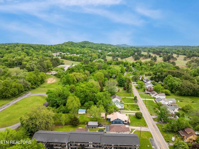 drone / aerial view with a residential view and a wooded view