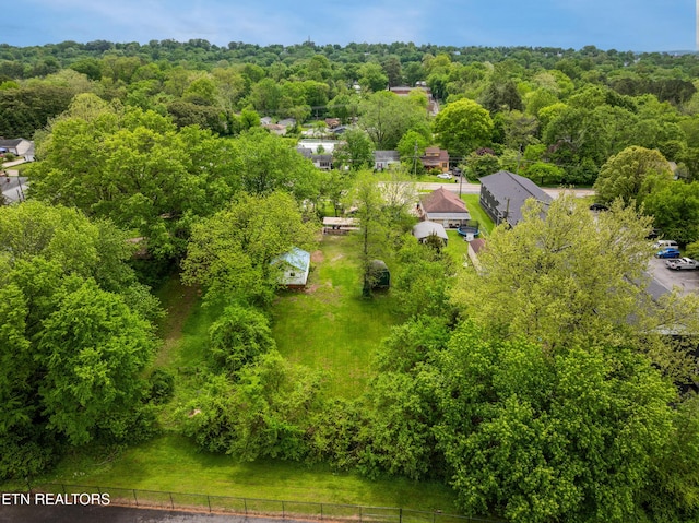 bird's eye view with a wooded view