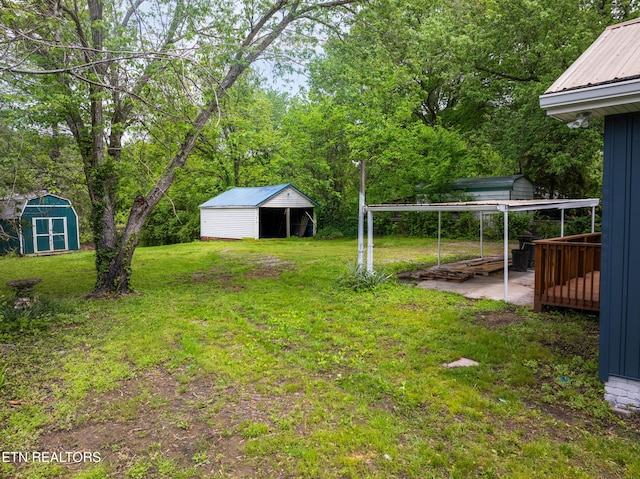 view of yard with a storage unit, an outdoor structure, and a detached carport