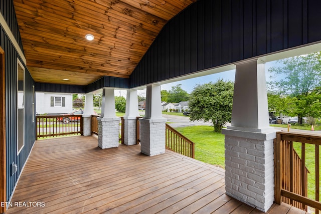 deck featuring covered porch and a lawn
