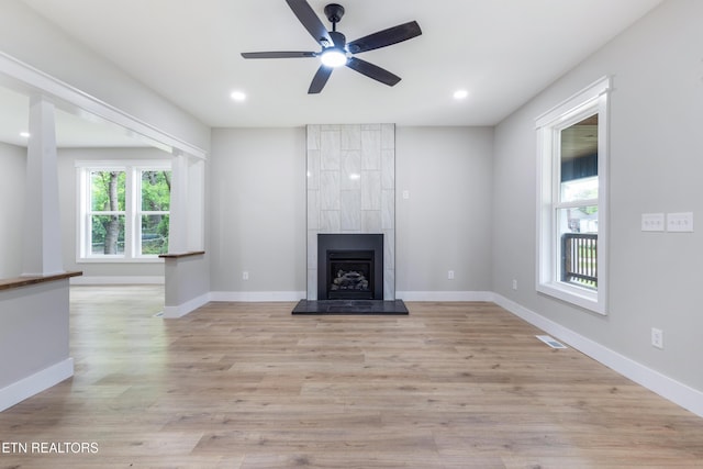 unfurnished living room featuring ceiling fan, light wood finished floors, a large fireplace, recessed lighting, and visible vents