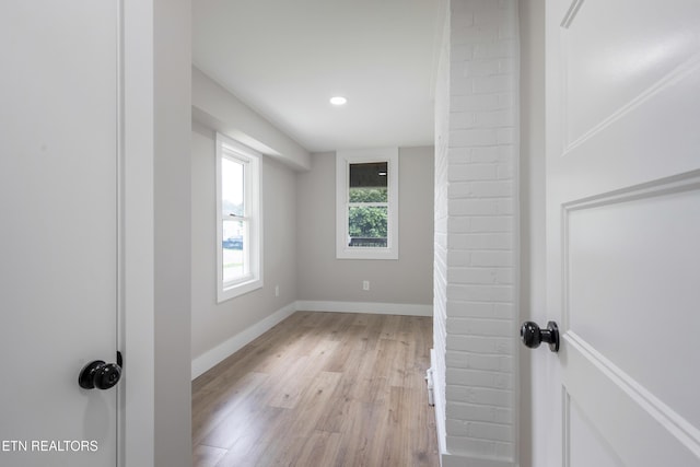 empty room with light wood-type flooring, recessed lighting, and baseboards
