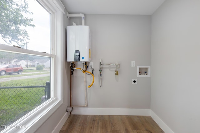 laundry room featuring electric dryer hookup, laundry area, a wealth of natural light, and water heater