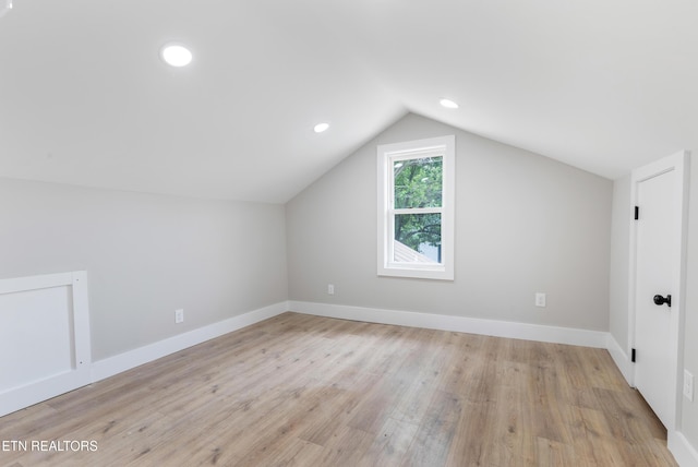 bonus room featuring baseboards, recessed lighting, wood finished floors, and lofted ceiling