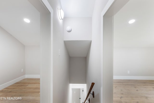 stairs with recessed lighting, baseboards, and wood finished floors
