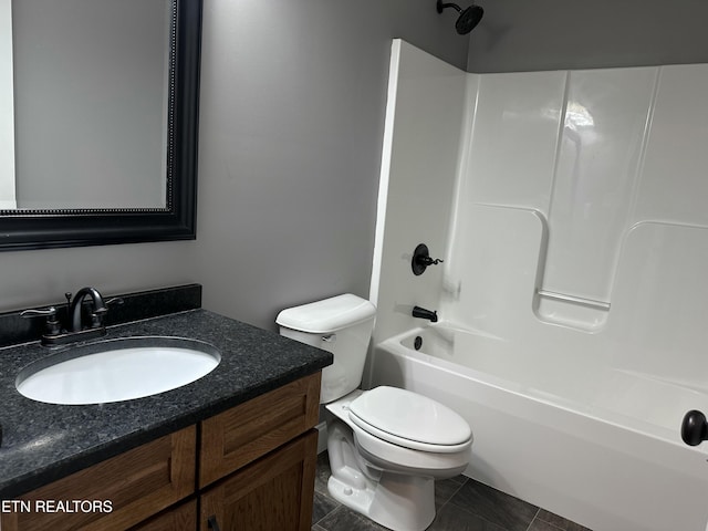 bathroom with vanity, tile patterned floors, washtub / shower combination, and toilet