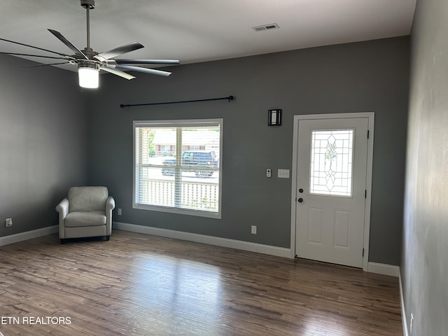 foyer featuring visible vents, baseboards, ceiling fan, and wood finished floors