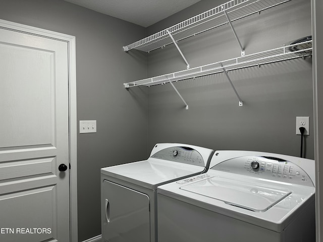 laundry area featuring laundry area and washer and clothes dryer