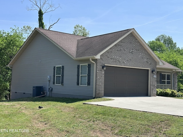 ranch-style home with an attached garage, a shingled roof, driveway, and a front yard