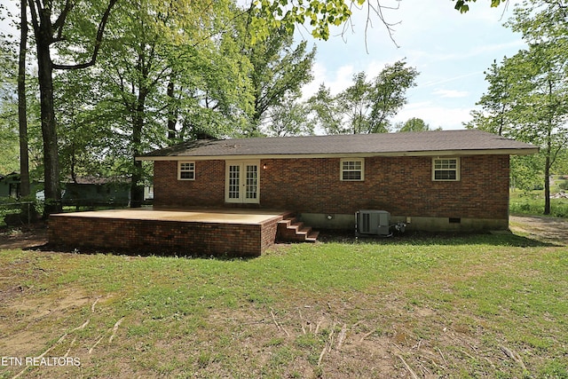 back of property with a yard, brick siding, french doors, and crawl space