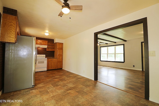 kitchen featuring brown cabinetry, freestanding refrigerator, under cabinet range hood, ceiling fan, and white range with electric cooktop