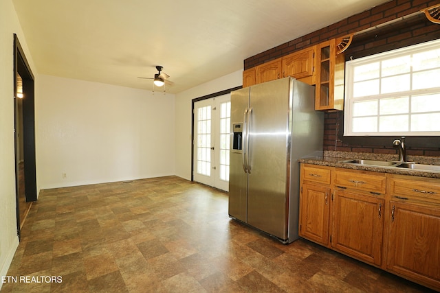 kitchen with french doors, a wealth of natural light, ceiling fan, a sink, and stainless steel refrigerator with ice dispenser