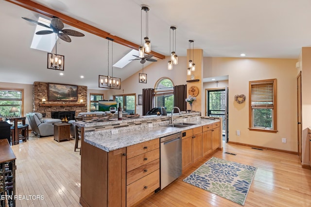 620 Hawk View Dr, Townsend, TN 37882 - kitchen featuring stainless steel dishwasher, ceiling fan, a fireplace, and a sink