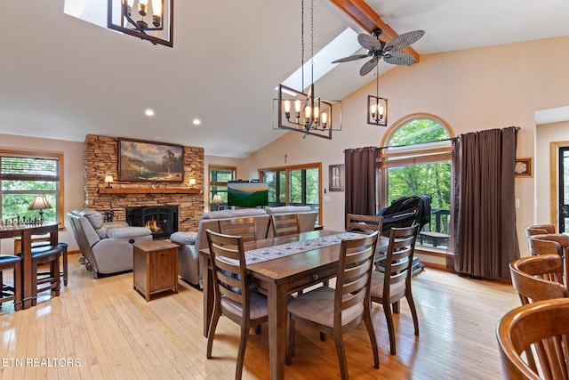 620 Hawk View Dr, Townsend, TN 37882 - dining space with a fireplace, high vaulted ceiling, a chandelier, plenty of natural light, and beamed ceiling
