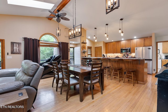620 Hawk View Dr, Townsend, TN 37882 - dining area featuring a chandelier, beam ceiling, light wood-type flooring, high vaulted ceiling, and a skylight