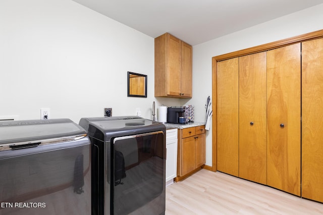 620 Hawk View Dr, Townsend, TN 37882 - laundry room with washing machine and dryer, light wood finished floors, and cabinet space