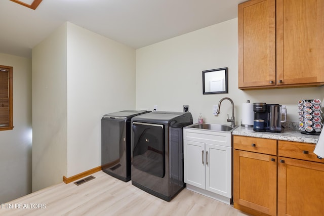 620 Hawk View Dr, Townsend, TN 37882 - washroom with washing machine and dryer, light wood-type flooring, cabinet space, and baseboards