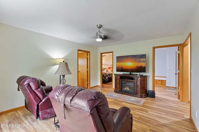 620 Hawk View Dr, Townsend, TN 37882 - living area featuring ceiling fan, light wood-style flooring, baseboards, and a glass covered fireplace