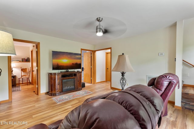 620 Hawk View Dr, Townsend, TN 37882 - living area with ceiling fan, light wood finished floors, baseboards, and a glass covered fireplace