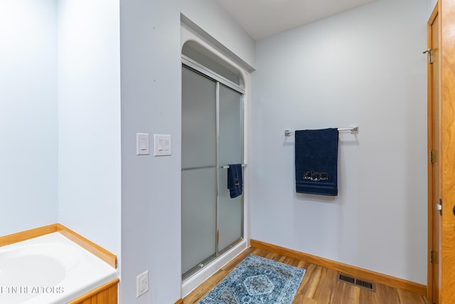 620 Hawk View Dr, Townsend, TN 37882 - bathroom featuring a shower stall, wood finished floors, baseboards, and a bath
