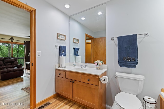 620 Hawk View Dr, Townsend, TN 37882 - bathroom featuring vanity, wood finished floors, toilet, baseboards, and recessed lighting