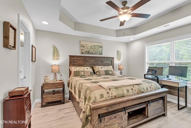 bedroom with visible vents, light wood-style floors, and baseboards