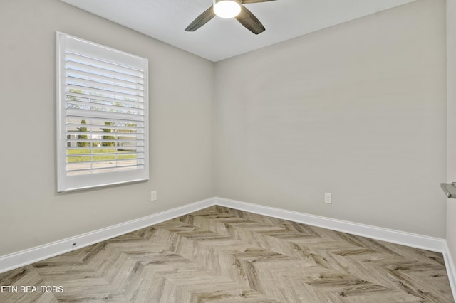 empty room featuring baseboards and a ceiling fan
