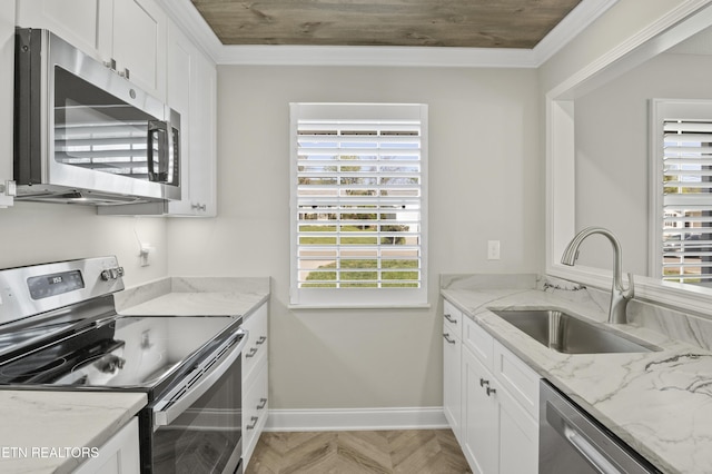 kitchen with a sink, plenty of natural light, stainless steel appliances, and white cabinets