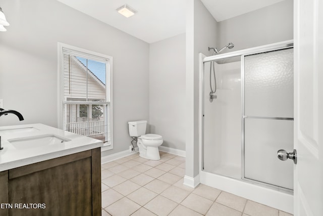 bathroom with tile patterned flooring, a stall shower, a sink, baseboards, and toilet