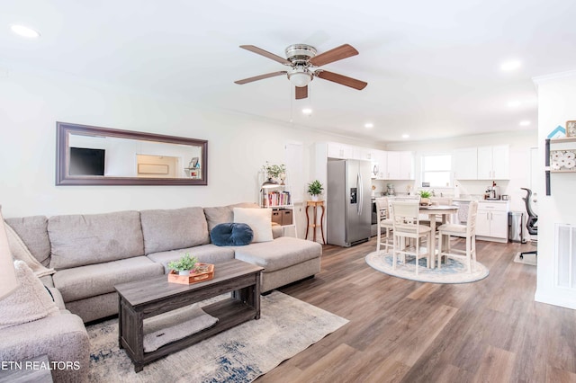 living room featuring light wood-style floors, a ceiling fan, recessed lighting, and visible vents