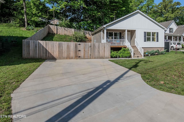 bungalow-style house featuring a porch, a front yard, a gate, fence, and stairs