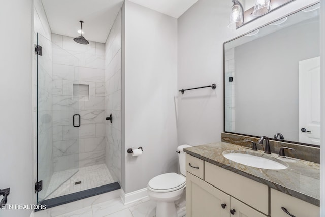 full bathroom with a shower stall, vanity, baseboards, toilet, and marble finish floor