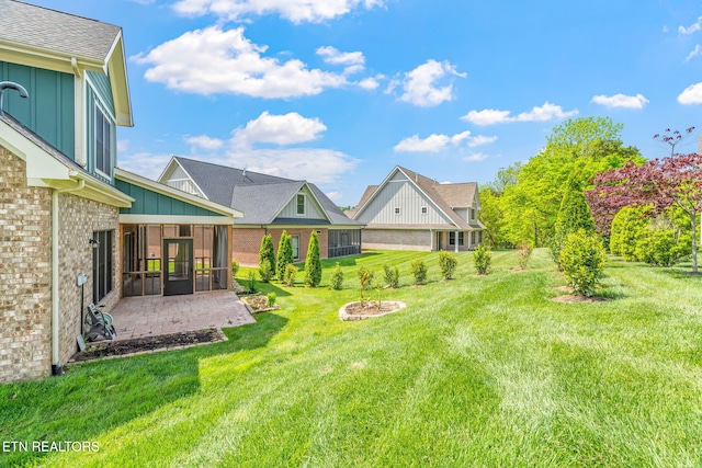 view of yard featuring a patio and a sunroom
