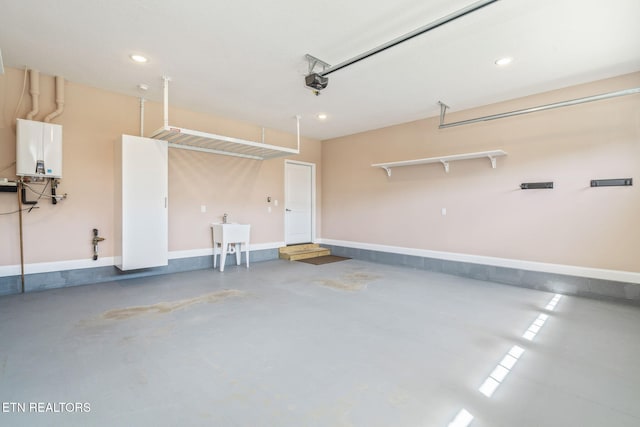 garage with recessed lighting, baseboards, tankless water heater, and a garage door opener