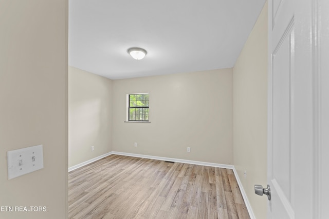 unfurnished room featuring light wood finished floors and baseboards