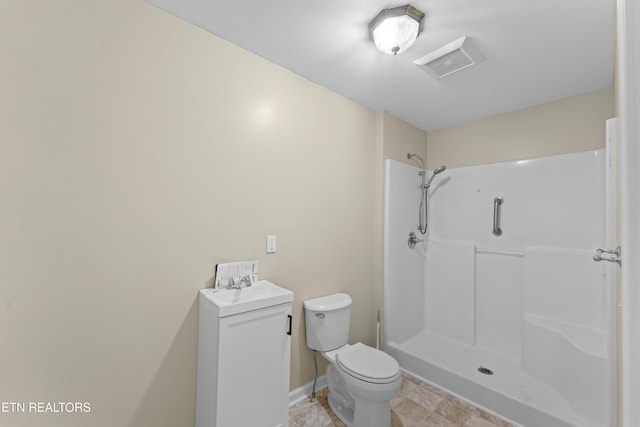 bathroom featuring toilet, a shower, visible vents, and a sink