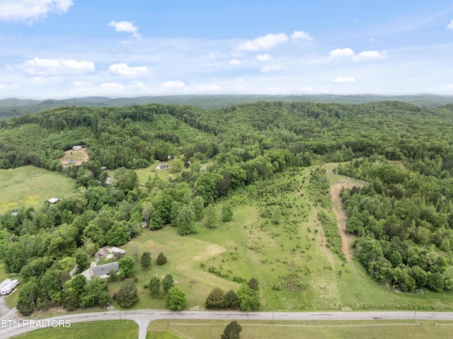 birds eye view of property featuring a view of trees