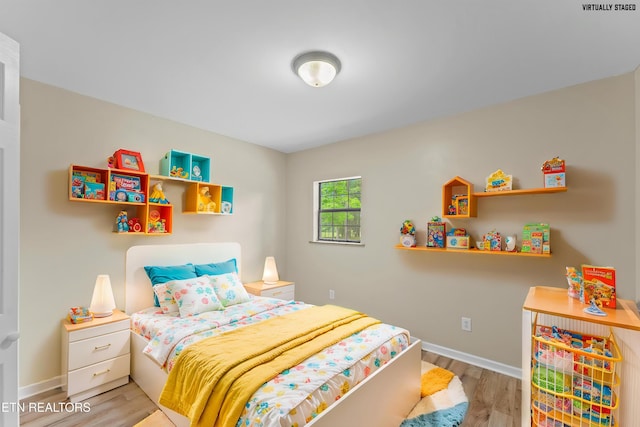 bedroom with wood finished floors and baseboards